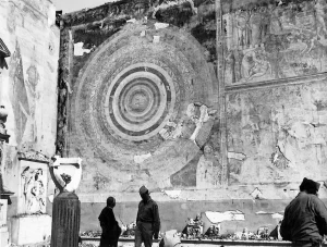 Historical WWII photograph of Monuments Man Captain Deane Keller and Monsignor Paolo Evangelisti inside the damaged Camposanto in Pisa, examining Piero di Puccio's Cosmografia fresco after the 1944 bombing.